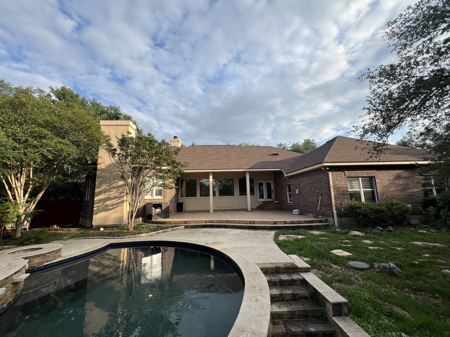San Marcos project before the remodel: original brick rear elevation and dated pool deck